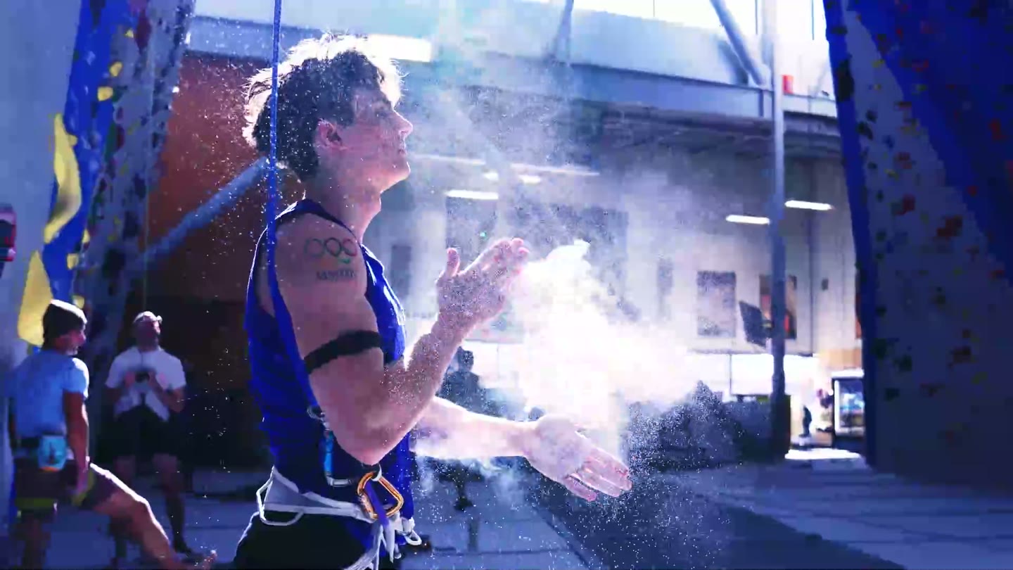 An Olympic speed climber chalking up before a run
