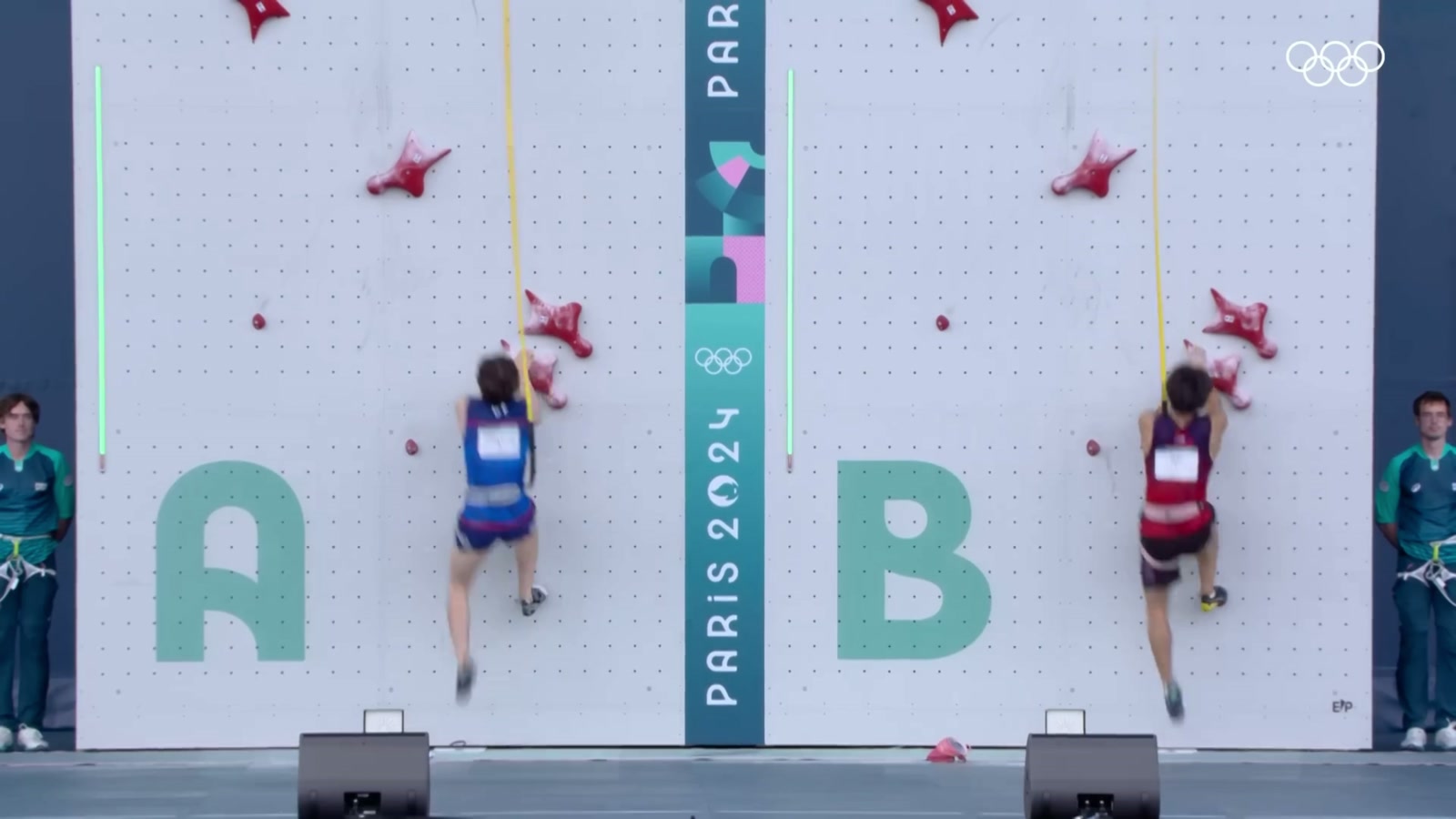 Two climbers racing side by side on the standardized speed wall at the Paris 2024 Olympics